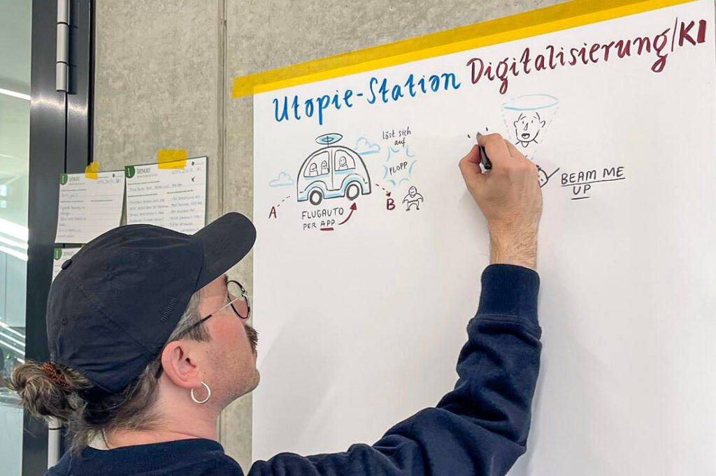 Die Ideen der Teilnehmer werden auf einem großen Poster von Graphiker Mike Klar umgesetzt